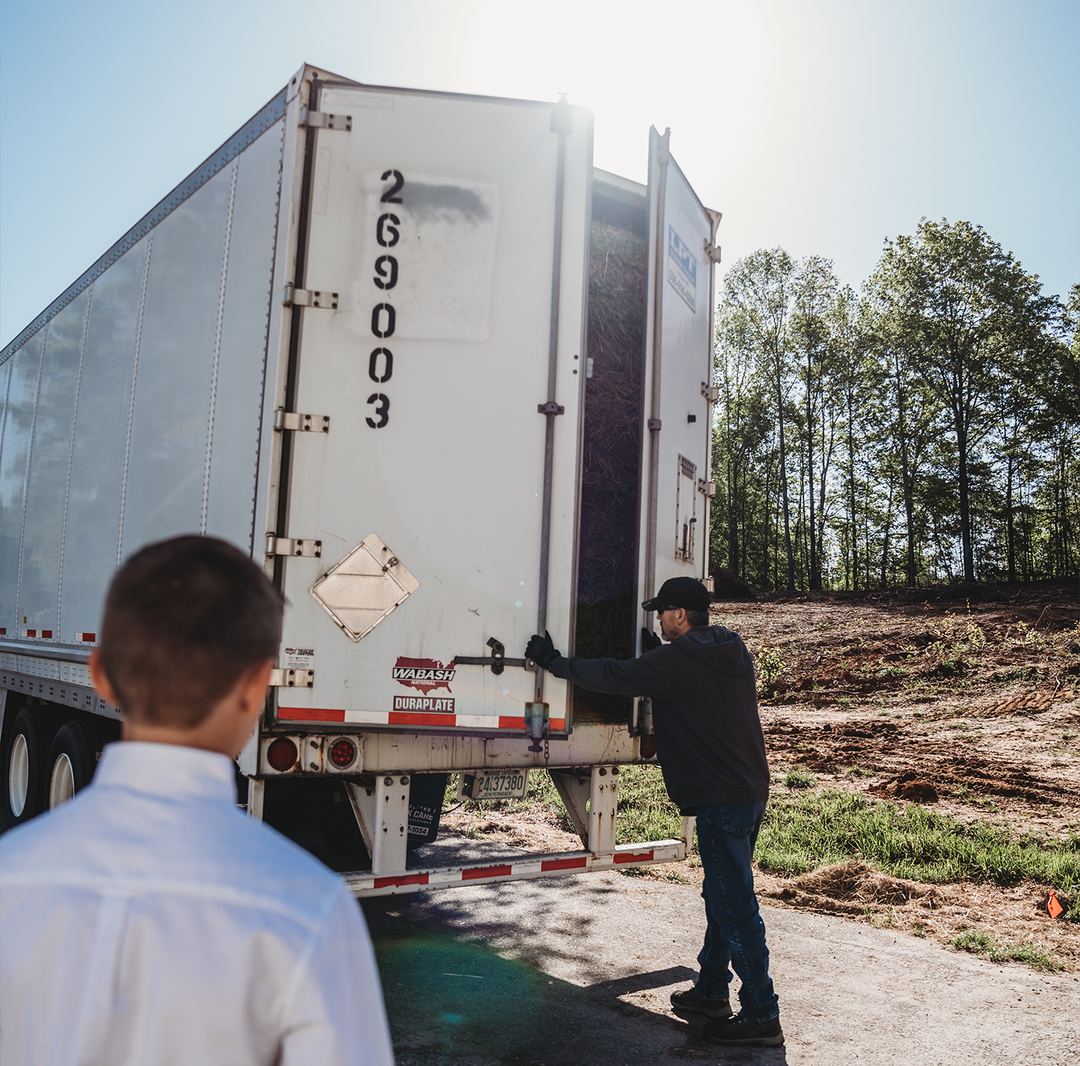 <img src="semitruck.jpg" alt="Man closing semi truck doors" />